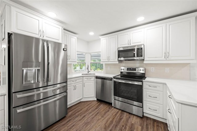6012 Perthshire Ln, Fort Myers, FL 33908 - kitchen with appliances with stainless steel finishes, white cabinetry, dark wood-style flooring, a sink, and recessed lighting