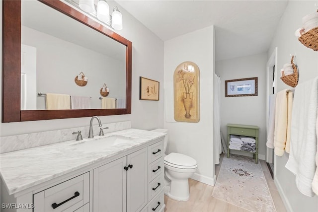 6012 Perthshire Ln, Fort Myers, FL 33908 - bathroom featuring vanity, toilet, and wood finished floors