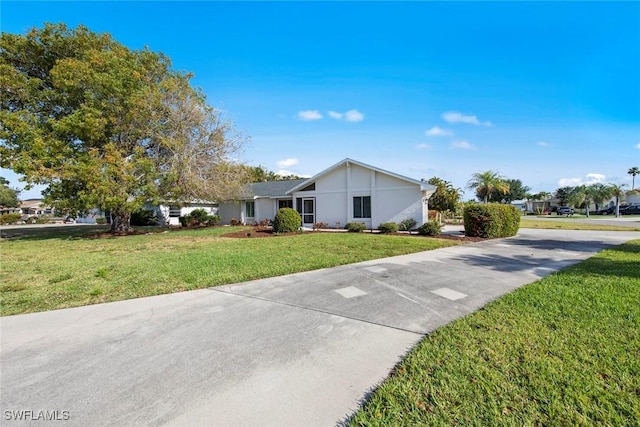 6012 Perthshire Ln, Fort Myers, FL 33908 - view of front of home featuring a front yard, driveway, and stucco siding