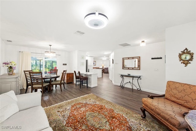 6012 Perthshire Ln, Fort Myers, FL 33908 - living area with dark wood-style flooring, baseboards, and a chandelier