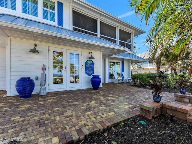 8315 Main St, Bokeelia, FL 33922 - property entrance featuring a patio, french doors, and metal roof