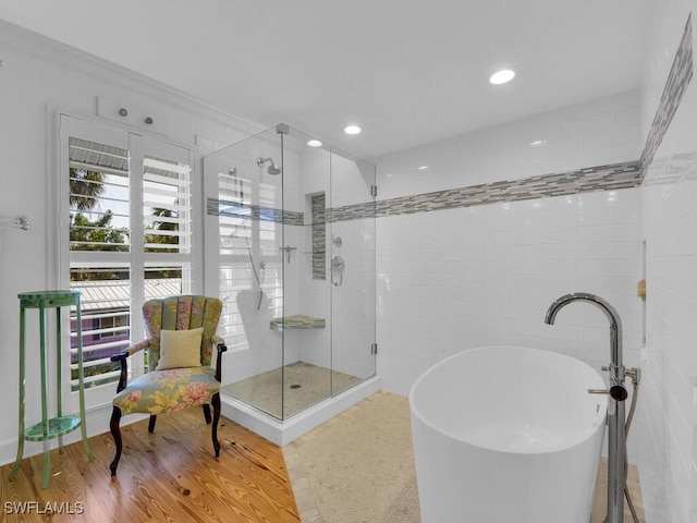 8315 Main St, Bokeelia, FL 33922 - bathroom with a freestanding tub, a shower stall, recessed lighting, and wood finished floors