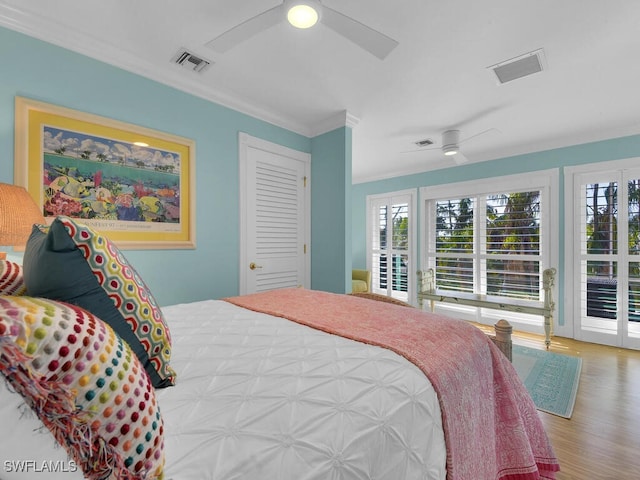 8315 Main St, Bokeelia, FL 33922 - bedroom with visible vents, wood finished floors, and multiple windows