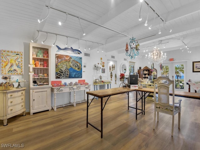8315 Main St, Bokeelia, FL 33922 - dining space featuring track lighting, beamed ceiling, wood finished floors, and visible vents