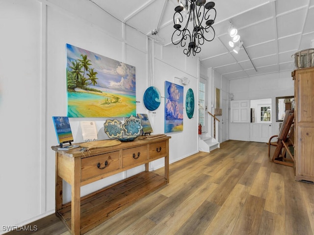 8315 Main St, Bokeelia, FL 33922 - corridor with an inviting chandelier and wood finished floors