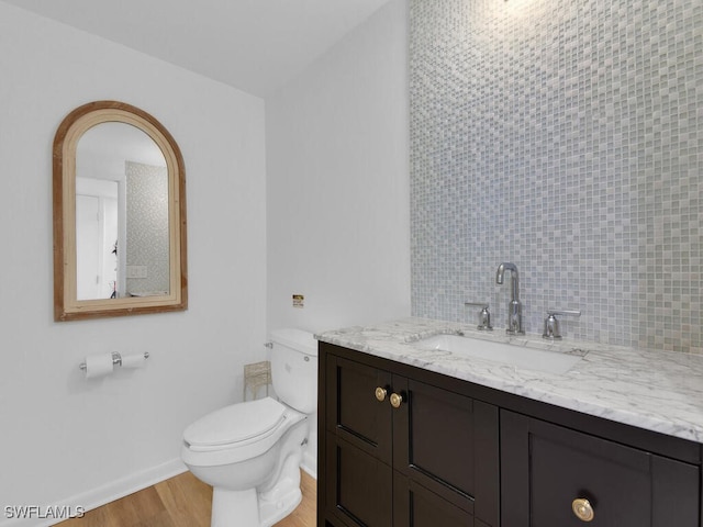 8315 Main St, Bokeelia, FL 33922 - bathroom with toilet, baseboards, wood finished floors, and vanity