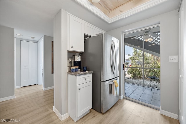 15400 River Vista Dr Unit 304, North Fort Myers, FL 33917 - kitchen featuring freestanding refrigerator, white cabinetry, baseboards, and light wood finished floors