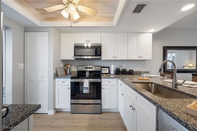 15400 River Vista Dr Unit 304, North Fort Myers, FL 33917 - kitchen with appliances with stainless steel finishes, a sink, light wood-style flooring, a tray ceiling, and visible vents