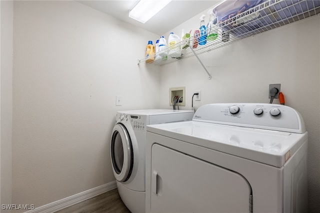15400 River Vista Dr Unit 304, North Fort Myers, FL 33917 - washroom featuring independent washer and dryer, laundry area, baseboards, and wood finished floors