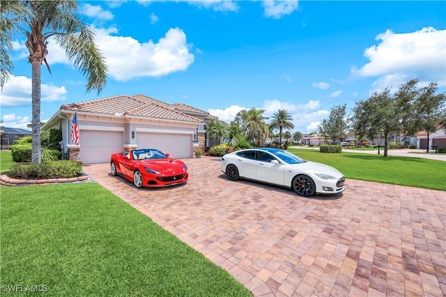 9052 Graphite Cir, Naples, FL 34120 - view of home's exterior featuring a garage, a lawn, decorative driveway, a tile roof, and stucco siding