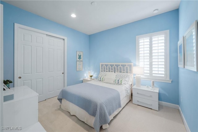 9052 Graphite Cir, Naples, FL 34120 - bedroom with light carpet, a closet, baseboards, and recessed lighting