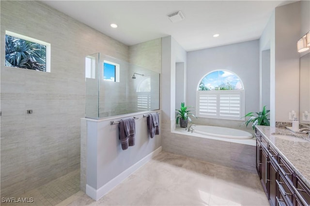 9052 Graphite Cir, Naples, FL 34120 - full bath featuring vanity, a garden tub, walk in shower, tile patterned flooring, and recessed lighting