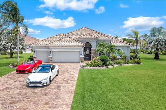 9052 Graphite Cir, Naples, FL 34120 - mediterranean / spanish house featuring decorative driveway, a garage, stucco siding, a front lawn, and a tiled roof