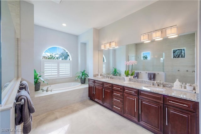 9052 Graphite Cir, Naples, FL 34120 - bathroom with double vanity, a bath, tile patterned flooring, and a walk in shower