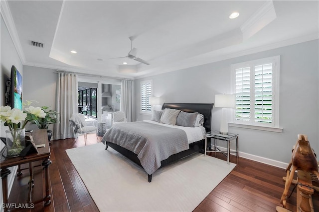 9052 Graphite Cir, Naples, FL 34120 - bedroom featuring a tray ceiling, multiple windows, ornamental molding, dark wood-style flooring, and recessed lighting