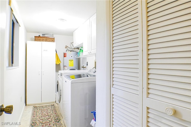 7116 Lakeridge Ct Unit 103, Fort Myers, FL 33907 - laundry room with washing machine and dryer, cabinet space, water heater, and baseboards