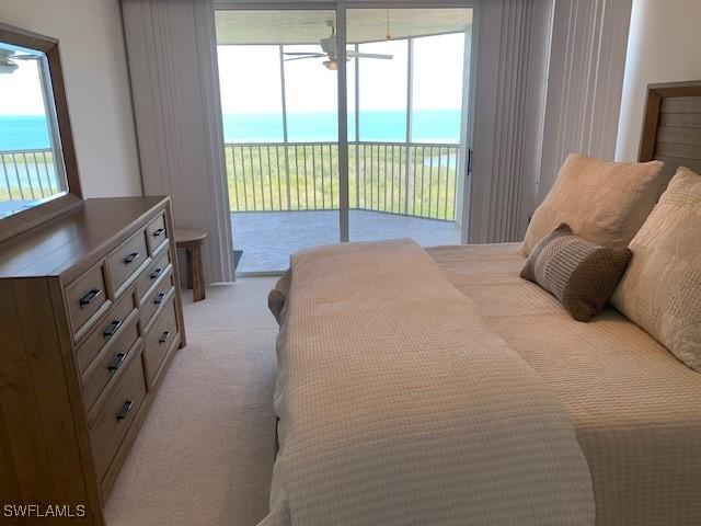 bedroom featuring light colored carpet and access to exterior