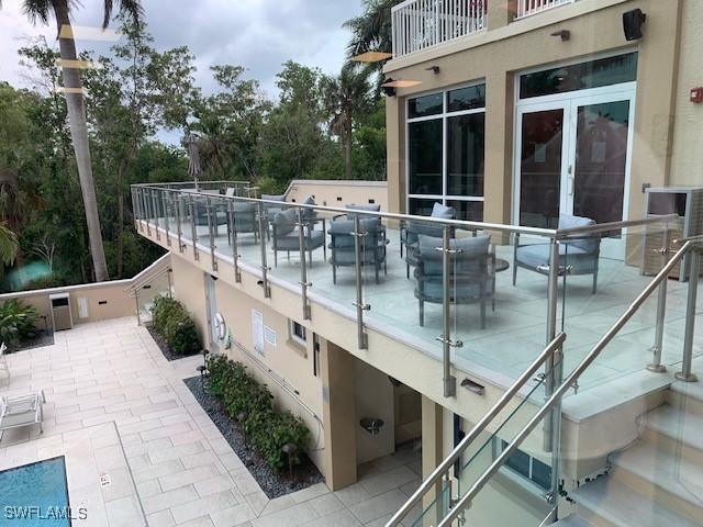 view of swimming pool with a patio and french doors