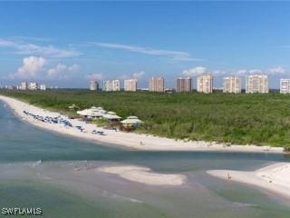 exterior space featuring a view of city, a beach view, and a water view