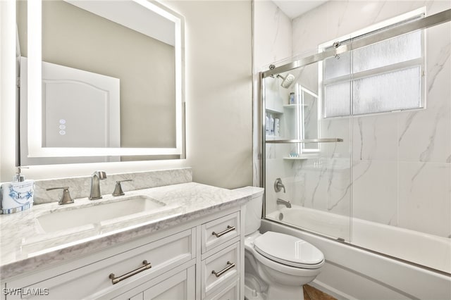 9890 Rookery Cir, Estero, FL 33928 - full bath with vanity, bath / shower combo with glass door, and toilet