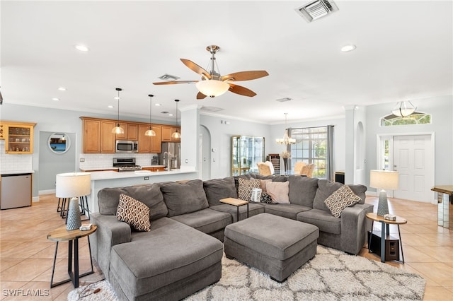 9890 Rookery Cir, Estero, FL 33928 - living room with crown molding, ceiling fan with notable chandelier, recessed lighting, light tile patterned floors, and visible vents