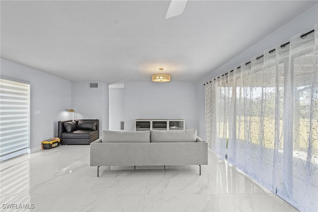 living area with visible vents and marble finish floor