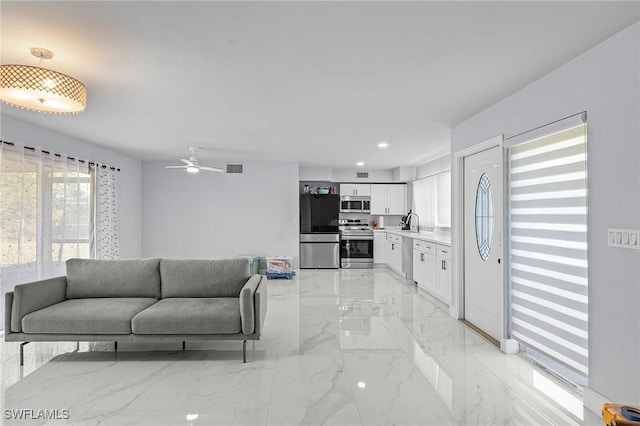 living area featuring visible vents, recessed lighting, a ceiling fan, and marble finish floor