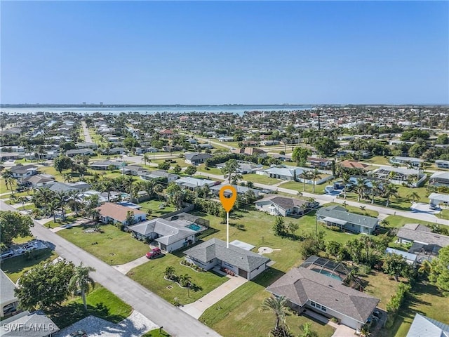 drone / aerial view with a water view and a residential view