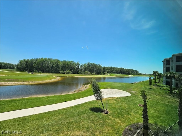 surrounding community featuring a lawn and a water view