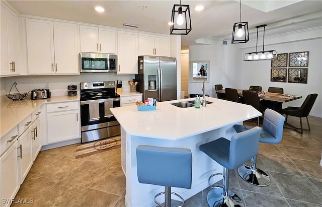 kitchen featuring recessed lighting, appliances with stainless steel finishes, a sink, white cabinetry, and visible vents