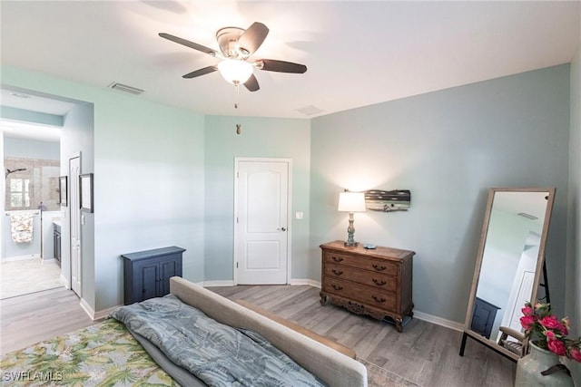 bedroom with baseboards, visible vents, and light wood-style flooring