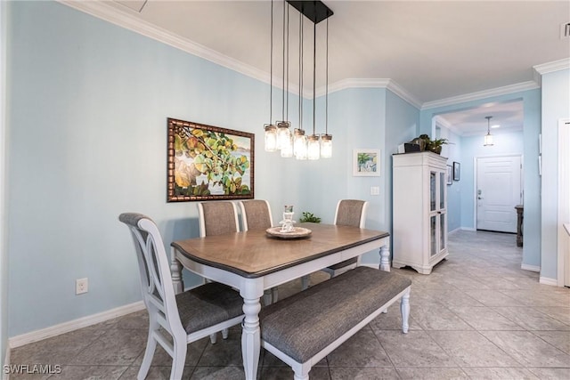 dining room featuring baseboards, visible vents, and ornamental molding