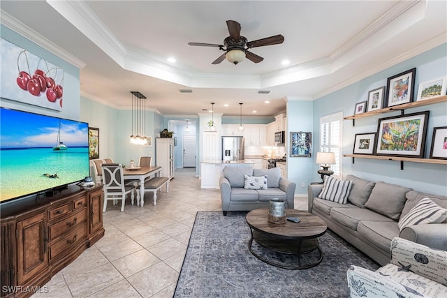 living room with ceiling fan, a raised ceiling, recessed lighting, light tile patterned floors, and ornamental molding