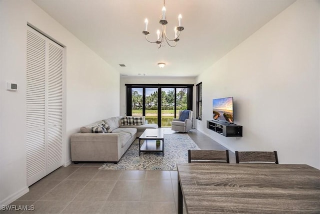 living area featuring an inviting chandelier, baseboards, tile patterned flooring, and visible vents