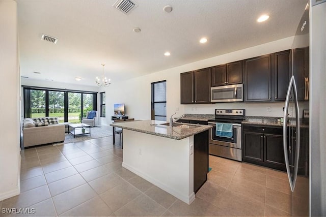 kitchen with visible vents, a sink, appliances with stainless steel finishes, and an inviting chandelier