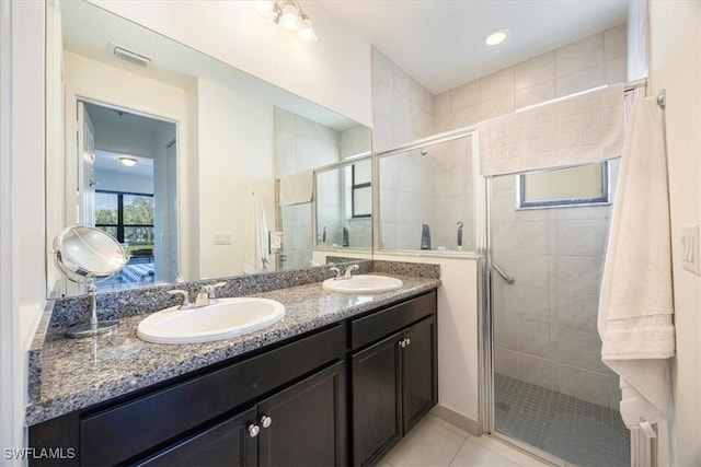 bathroom with visible vents, a sink, and a stall shower