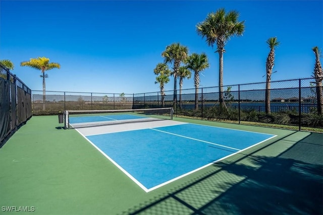 view of tennis court featuring fence