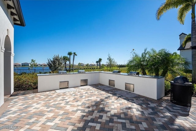 view of patio featuring fence and exterior kitchen