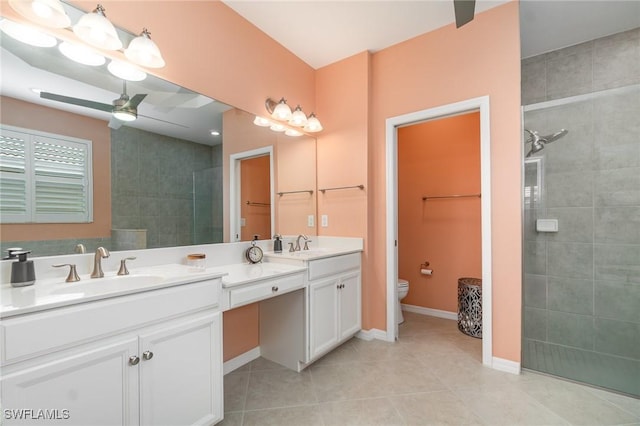 bathroom with double vanity, toilet, ceiling fan, a walk in shower, and tile patterned floors