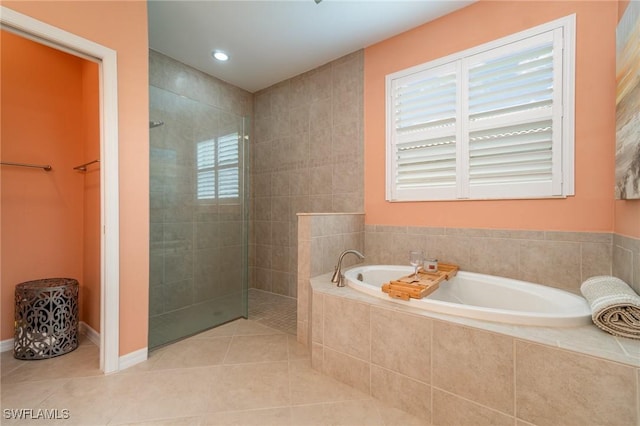 full bathroom with tile patterned flooring, a walk in shower, and a bath
