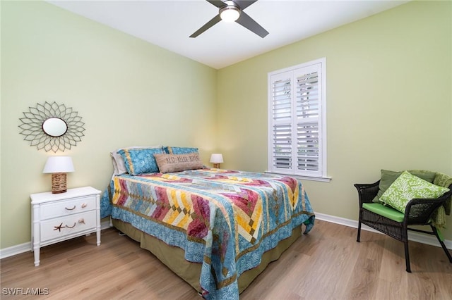 bedroom with baseboards, ceiling fan, and wood finished floors