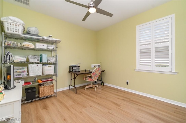 office area with a ceiling fan, baseboards, visible vents, and wood finished floors