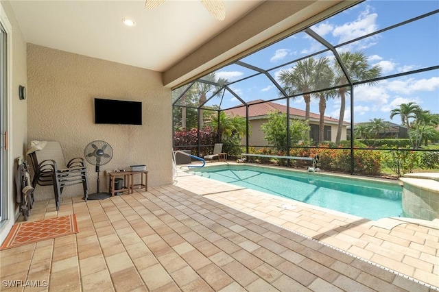 outdoor pool with a lanai and a patio area