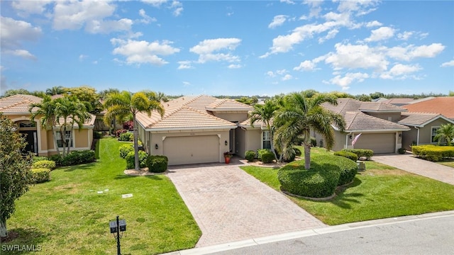 view of front of property featuring decorative driveway, an attached garage, a tile roof, and a front lawn