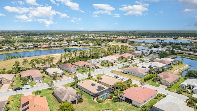 drone / aerial view with a residential view and a water view
