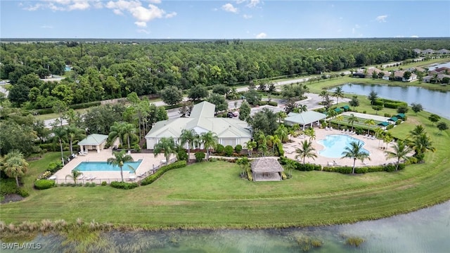 birds eye view of property with a water view and a view of trees