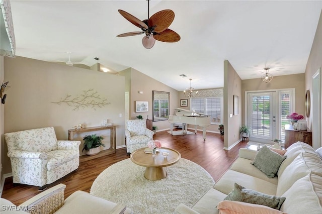 living room featuring a wealth of natural light, lofted ceiling, and wood finished floors