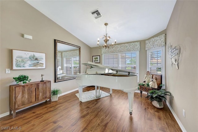 sitting room featuring baseboards, visible vents, wood finished floors, and lofted ceiling
