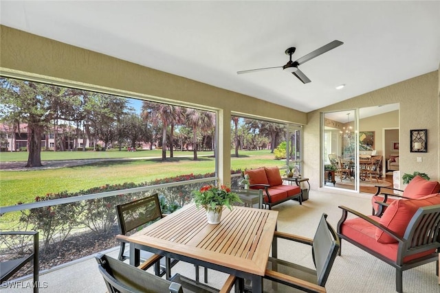sunroom with ceiling fan, outdoor dining space, and an outdoor hangout area