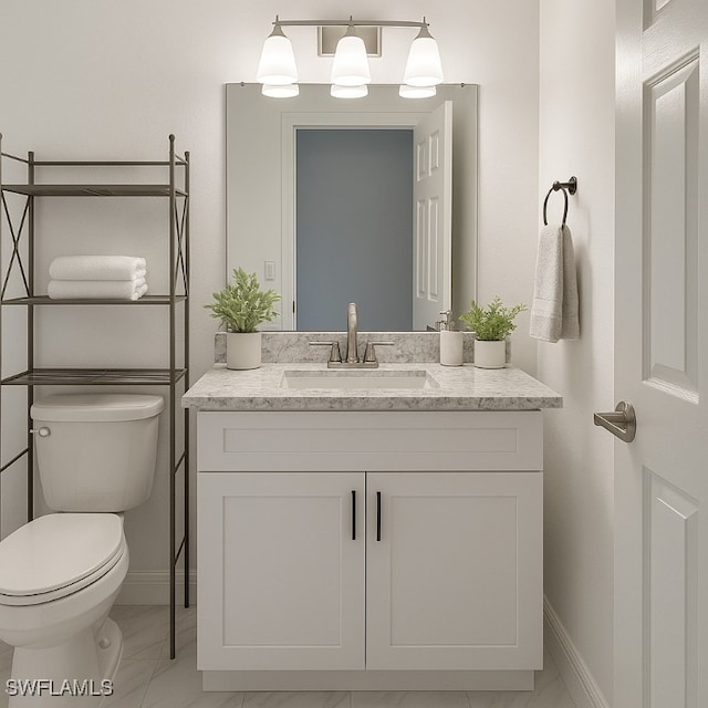 428 Meadowlark Ln Unit A, Naples, FL 34105 - half bathroom with vanity, baseboards, and toilet